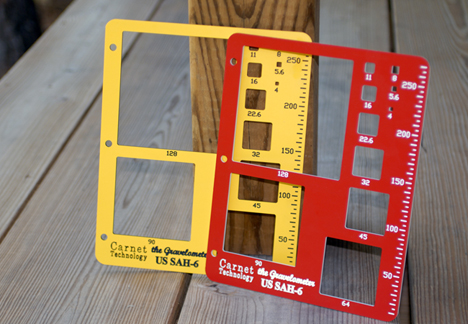 US SAH-6Y yellow and US SAH-6R red gravelometers leaning against a wooden post